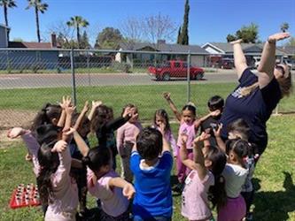 PreK students playing with their teacher